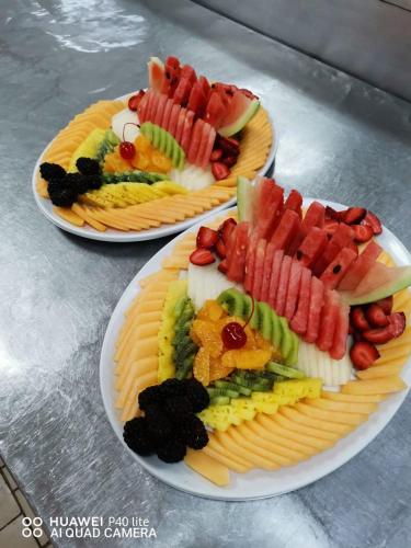 two plates of different types of food on a table at Tamboti Guest Lodge in Pretoria