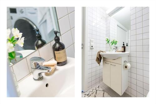 uma casa de banho com um lavatório e uma garrafa de vinho em Luxurable super central 3 BR apt for a family of 6 in Oslo em Oslo