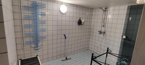 uma casa de banho com um chuveiro com um cortador de vidro azul em Saarijärvi - Omakotitalo, oma ranta em Kolkanlahti