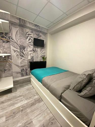 a bedroom with a bed and a wall at Pillows CoLiving in Hong Kong