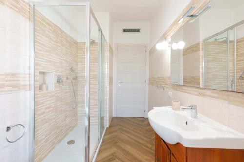 a bathroom with a white sink and a shower at exclusive use swimming pool available from June to September in Cagliari