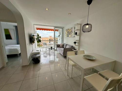 a living room with a table and a couch at Achacay View Apartment in Los Cristianos