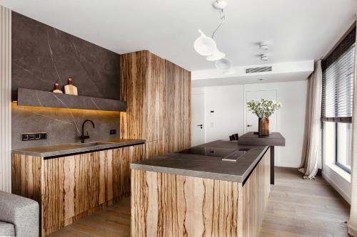 a kitchen with wooden cabinets and a sink at PANORAMA VIEW by Mint Apartment in Krakow