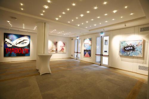 a large room with paintings on the walls at Soul Art Hotel in Naples