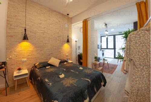a bedroom with a bed and a brick wall at Artistic Designer Getaway - Digital Nomads + Couples in Valencia