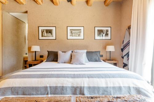 a bedroom with a large bed with two lamps at Rancho Adobe Eco Hotel in Tupungato