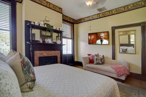 a bedroom with a bed and a fireplace and a mirror at Azalea Inn and Villas in Savannah
