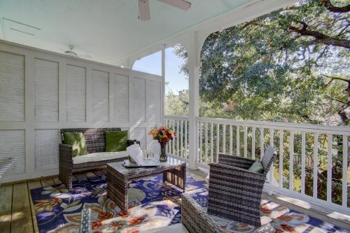 a screened in porch with chairs and a table at Azalea Inn and Villas in Savannah