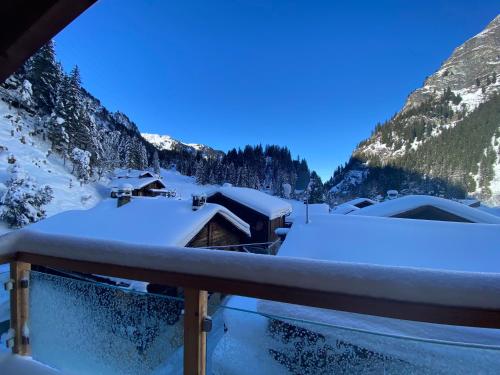 a room with snow on the roofs of buildings at BnB Le Mazot Fionnay in Fionnay