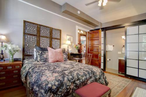 a bedroom with a large bed and a desk at Azalea Inn and Villas in Savannah