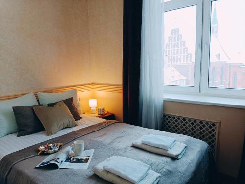 um quarto com uma cama com duas toalhas em Old Town Retreat with Stunning Views 2 bedroom Apartment em Riga