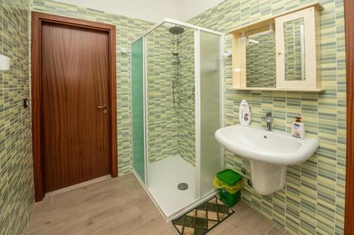 a bathroom with a sink and a glass shower at La Vecchia Cascina in Atena Lucana