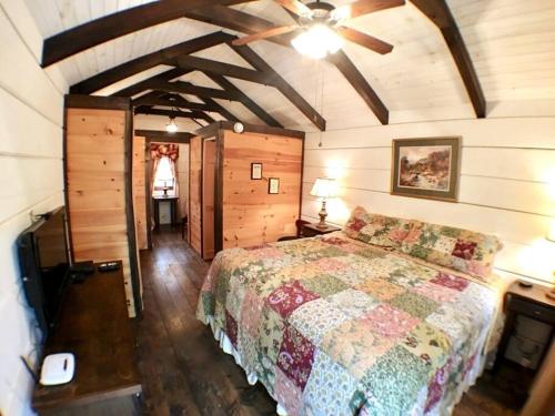 a bedroom with a bed and a ceiling at Tiny Home Cottage Near the Smokies #2 Lotte in Sevierville
