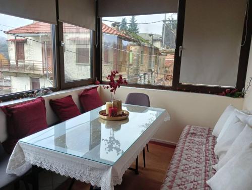 a living room with a table and a couch at Dimitra's traditional house in Katarráktis