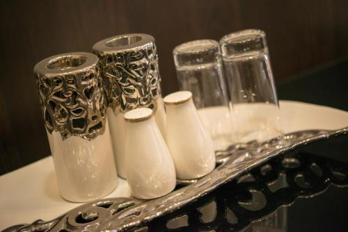 a group of vases sitting on top of a table at VVP Club Hotel in Tiraspol
