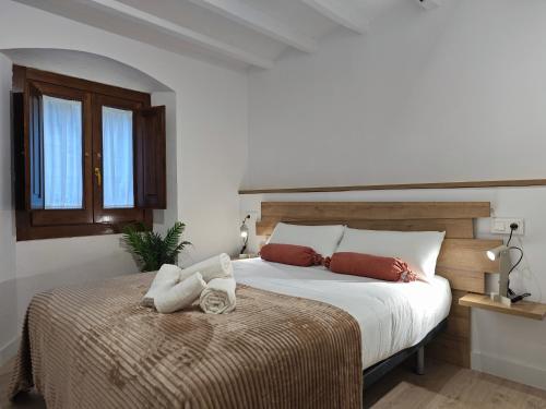 a bedroom with a large white bed and windows at Can Carisma in Camprodon