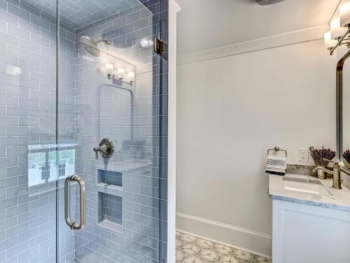 a bathroom with a shower with blue tiles at Amazing stay with beach access and heated pool, walking to restaurants, bars, and shopping in Tybee Island