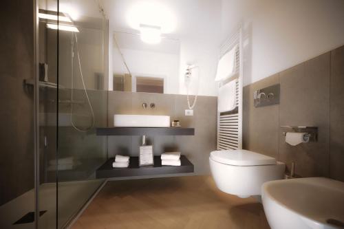 a bathroom with a toilet and a sink and a shower at Bergamo Inn 43 in Bergamo