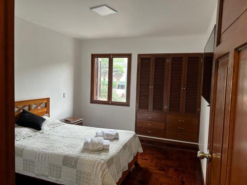 a bedroom with a bed and a window at Luxury Apartment Barranco Malecon in Lima