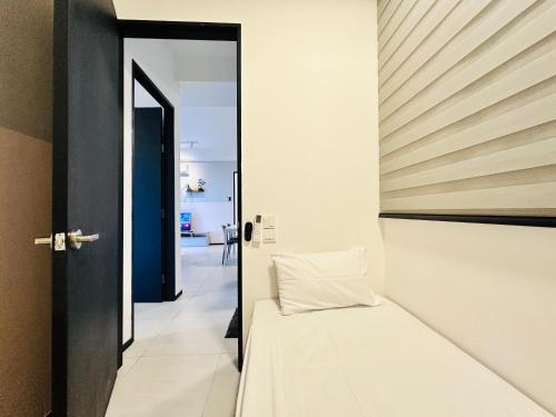 a bedroom with a bed and an open door at Urban Suite Cozy Family Homestay at Georgetown by URBAN STAYCATION HENG LOD in Jelutong