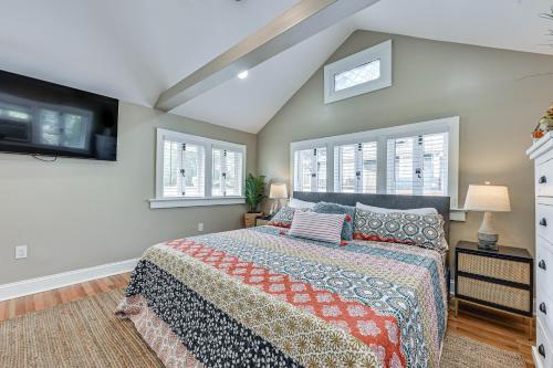 a bedroom with a king sized bed and windows at Cozy Jacksonville Cottage, Walkable Location! in Jacksonville