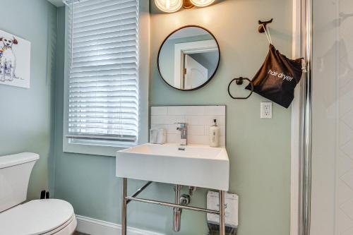 a bathroom with a sink and a mirror at Cozy Jacksonville Cottage, Walkable Location! in Jacksonville