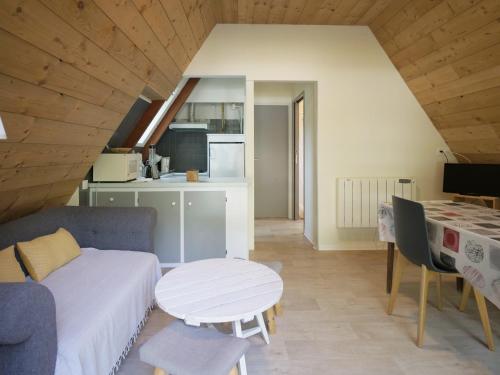 a living room with a couch and a table at Hotel Le Chalet in Sainte-Marie-de-Campan