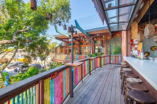 a balcony of a restaurant with a bar and chairs at The Folly Feeling 1 Block to Beach in Folly Beach