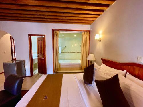 En eller flere senge i et værelse på Hotel Puebla Plaza