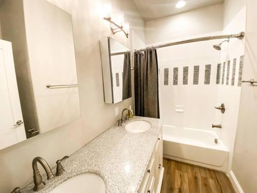 uma casa de banho branca com um lavatório e uma banheira em Custom Dream home, loft/porch, trendy neighborhood em Colorado Springs