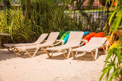 three lounge chairs sitting on the beach in the sand at MARIBELLA@CRYSTAL COVE OCHO RIOS in Stanmore Grove