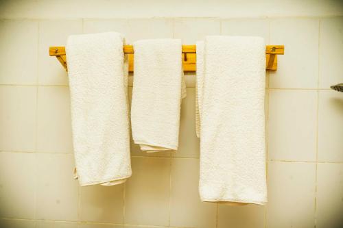 três toalhas penduradas num toalheiro na casa de banho em Room in Guest room - Isange Paradise Resort em Ruhengeri