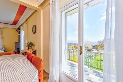 a room with a door open to a balcony at Country Home Genesi 20 min from Trikala in Genésion