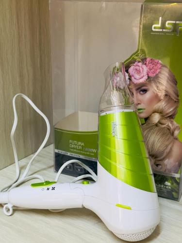 a hair dryer sitting on a counter next to a magazine at ENG-Murjan Apartment in Aqaba