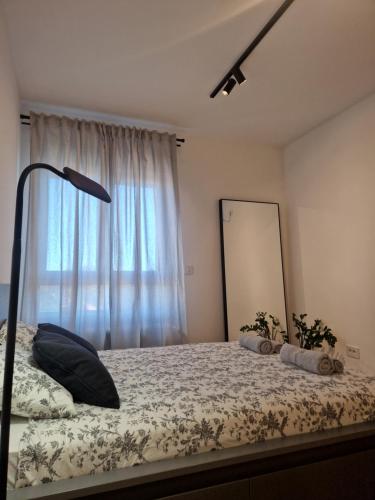 a bedroom with a bed with a large window at Studio mini54 in Belgrade