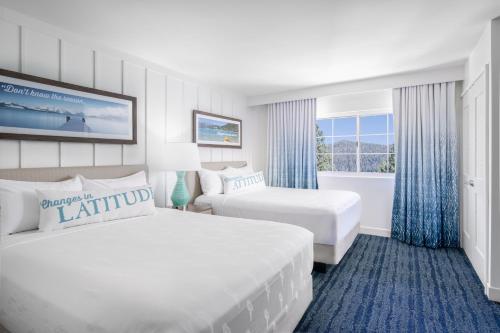 a hotel room with two beds and a window at Margaritaville Resort Lake Tahoe in South Lake Tahoe