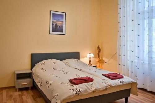 a bed with two red towels on it in a bedroom at casa max in Timişoara