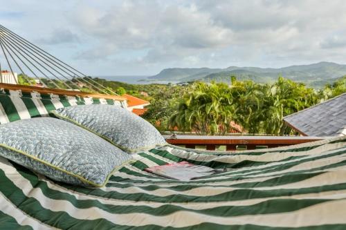 two pillows sitting in a hammock on a house at Newly renovated 3-bed spacious family home - Villa Decaj home in Cap Estate