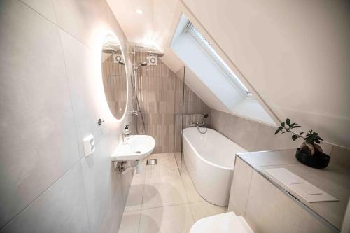 a white bathroom with a sink and a toilet at Unique Experience in Oslo's Heart in Oslo