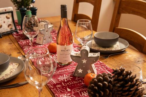 a table with a bottle of wine and wine glasses at The Cart House in Southampton