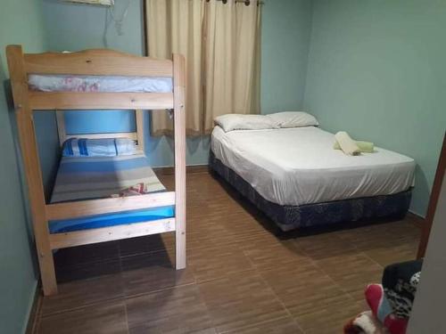 a small bedroom with two bunk beds in it at Frontera Apart in Puerto Iguazú