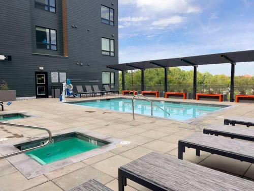a swimming pool in front of a building at Boho-Luxe Studio - Pink Accents & Mountain Calm in Boise