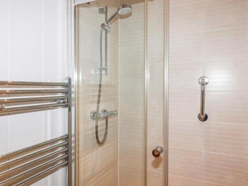 a shower with a shower head in a bathroom at 2 Stonerush Valley in Looe