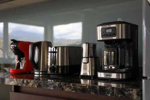 a counter with a coffeemaker and a coffee maker at El Carmelo Mountain Lodge in Potrerillos