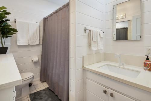 a bathroom with a sink and a toilet and a mirror at Quaint 1BD/1BA Bungalow- Venice Beach in Los Angeles