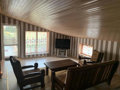 a living room with a couch and a table at Saldus sapnas in Rokiškis