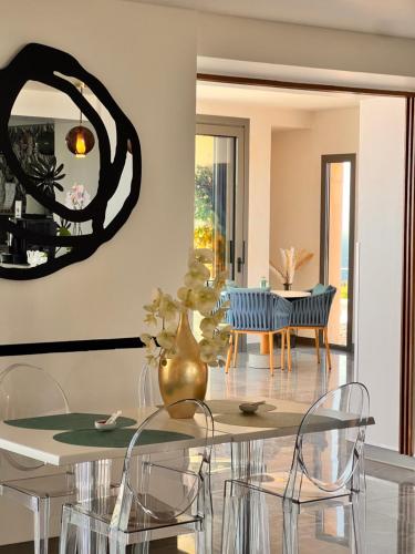 a dining room with a table with a vase at Santateresa in Bonifacio