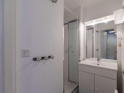 a white bathroom with a sink and a shower at Spacieux T2 centre ville avec WIFI et équipements sportifs - FR-1-401-274 in Cauterets