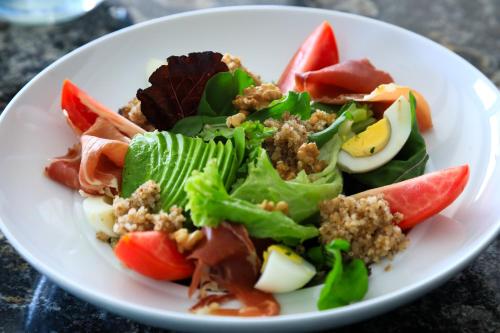 a salad on a white plate on a table at El Carmelo Mountain Lodge in Potrerillos