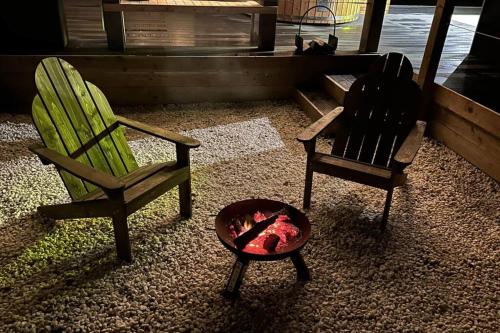 a living room with two chairs and a dog bowl at Clyde Croft - (Luxury Cabin) in Portpatrick